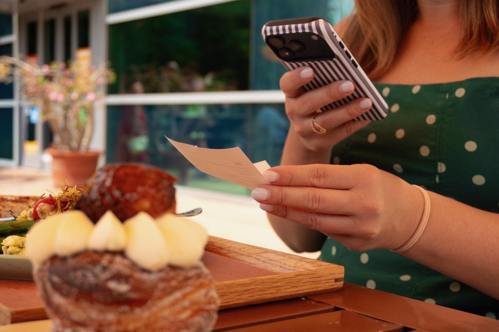 Small business owner capturing a paid receipt with her phone — categorizing the expense in real time.